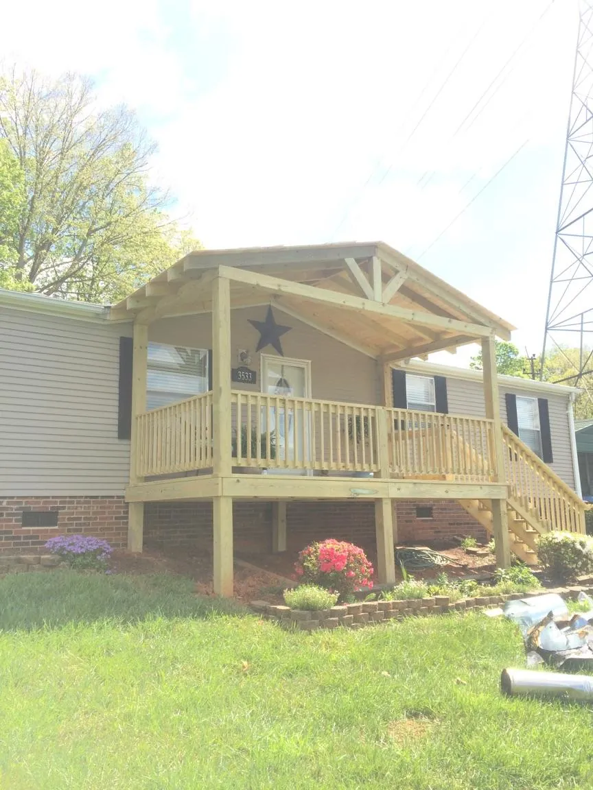 New gabled porch roof and deck railing added to a ranch home in Sheridan